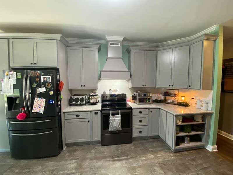 A gourmet kitchen with a professional-grade stove, marble countertops, and an expansive island for food preparation. The space is ideal for cooking and entertaining.