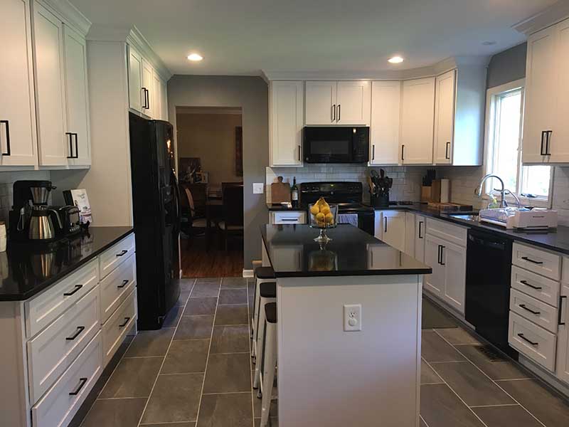 A modern kitchen renovation, white cabinetry, quartz countertops, and state-of-the-art stainless steel appliances.