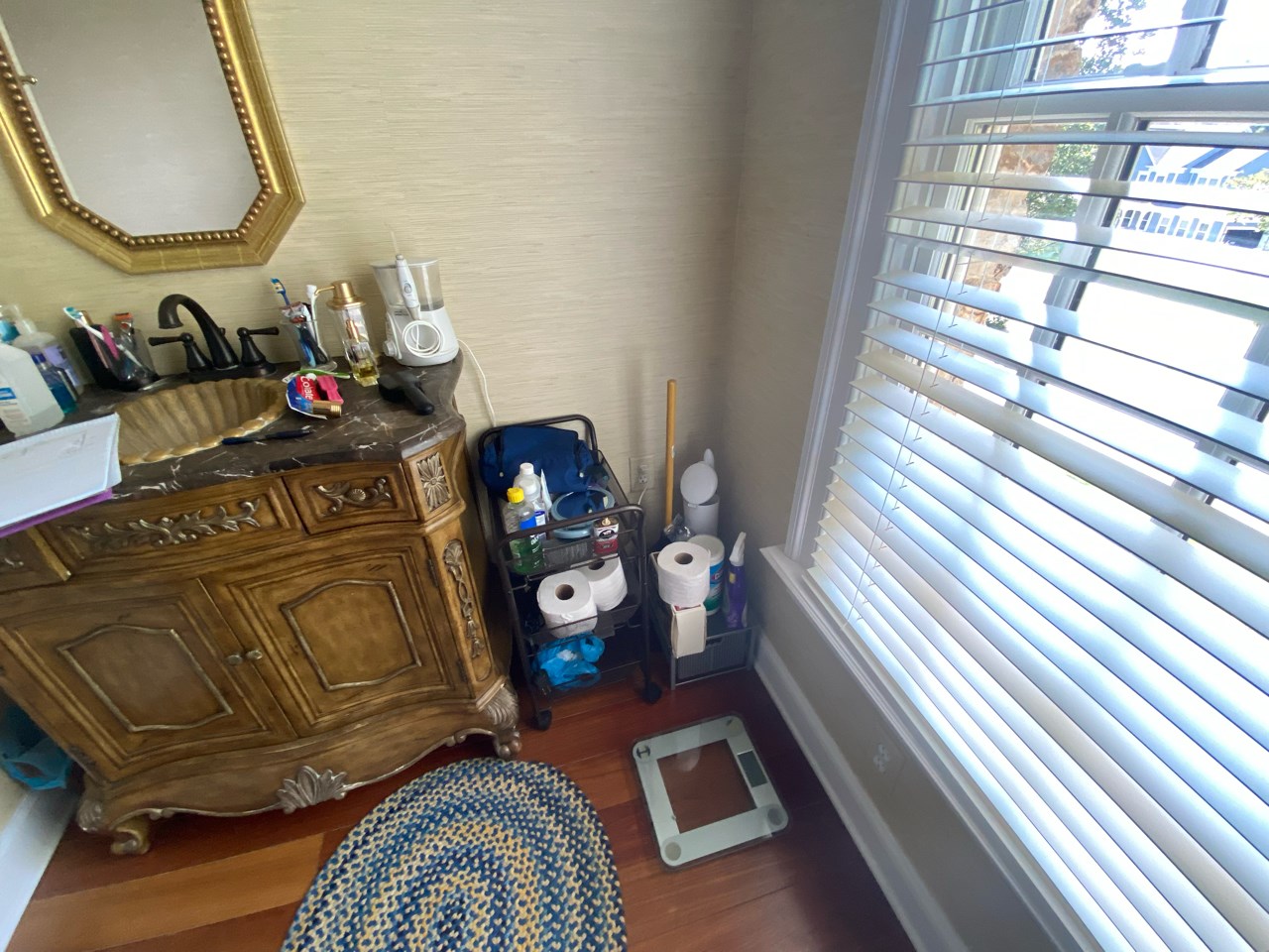 An old bathroom with a worn vintage sink and mirror.