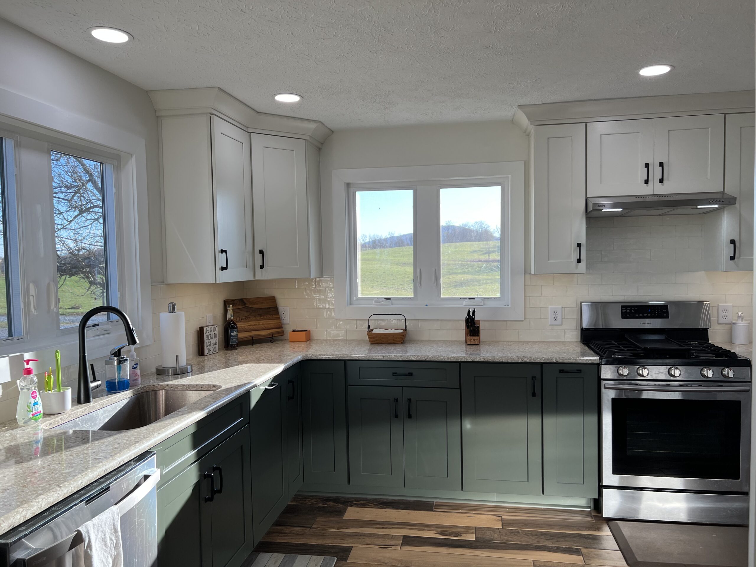 A contemporary kitchen with a fresh design, boasting glossy gray cabinets, quartz countertops, and a chic mosaic tile backsplash.