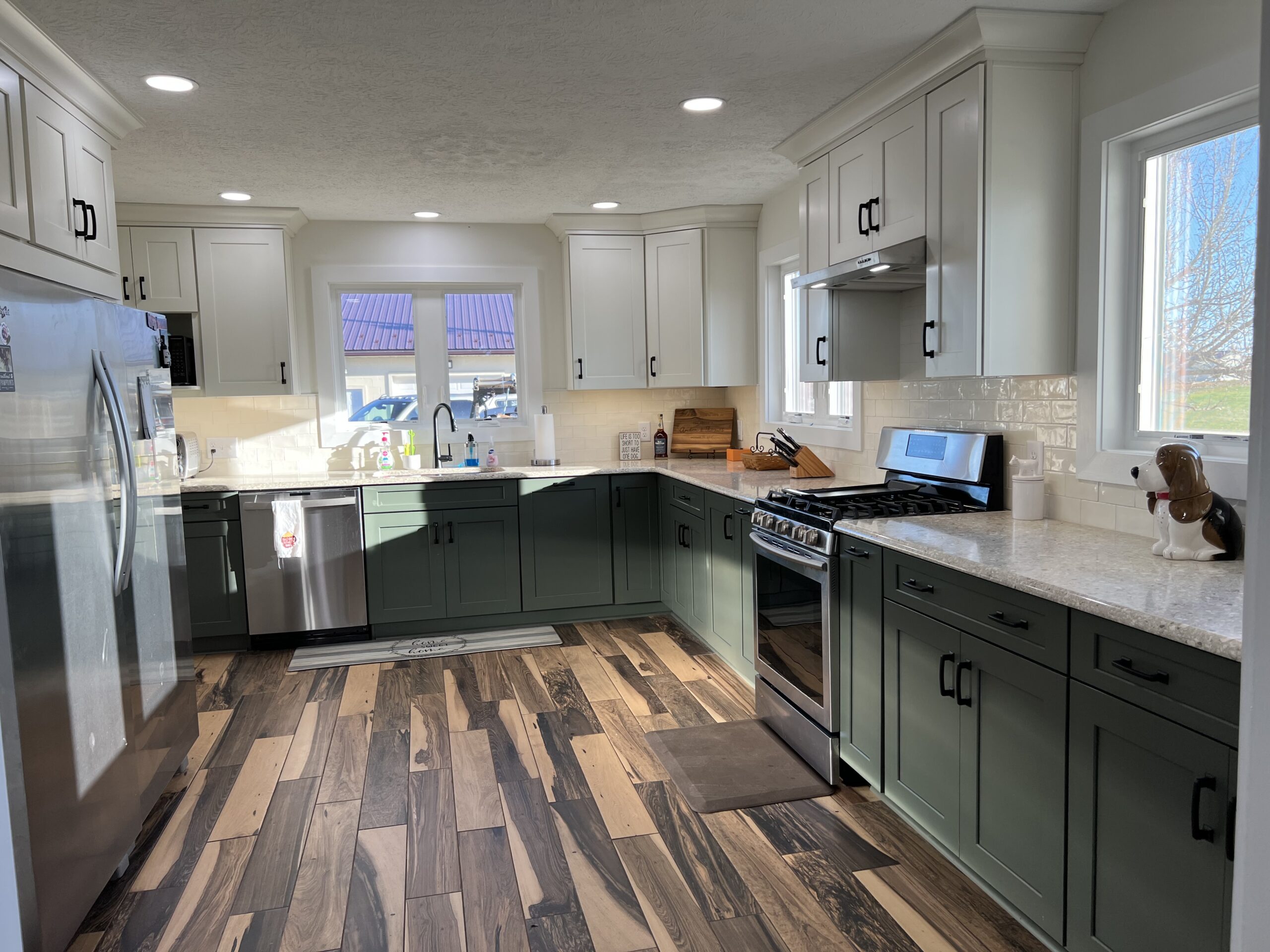 A modern kitchen renovation, white cabinetry, quartz countertops, and state-of-the-art stainless steel appliances.