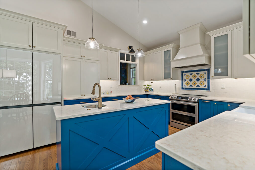 blue kitchen cabinets with island and appliances