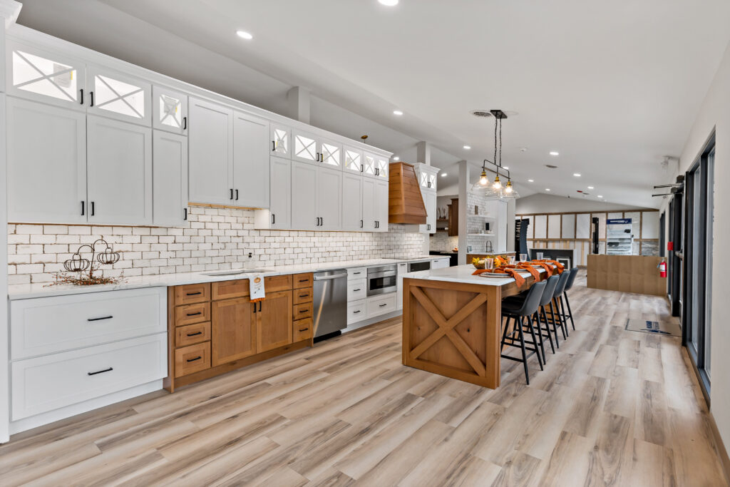 Showroom kitchen display with white cabinets and a wood island