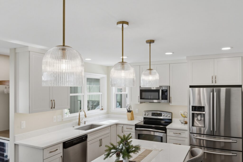 White kitchen with ribbed glass pendants