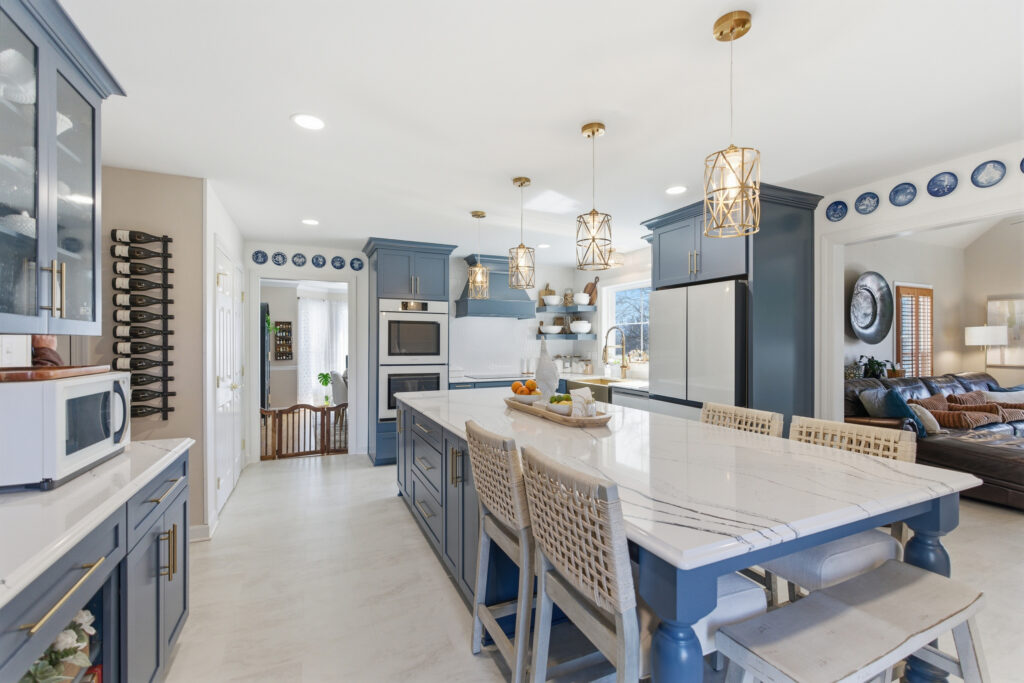 Kitchen with a slate blue island, quartz top and woven counter stools