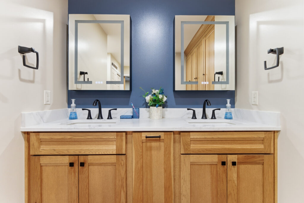 Double wood vanity against a navy accent wall
