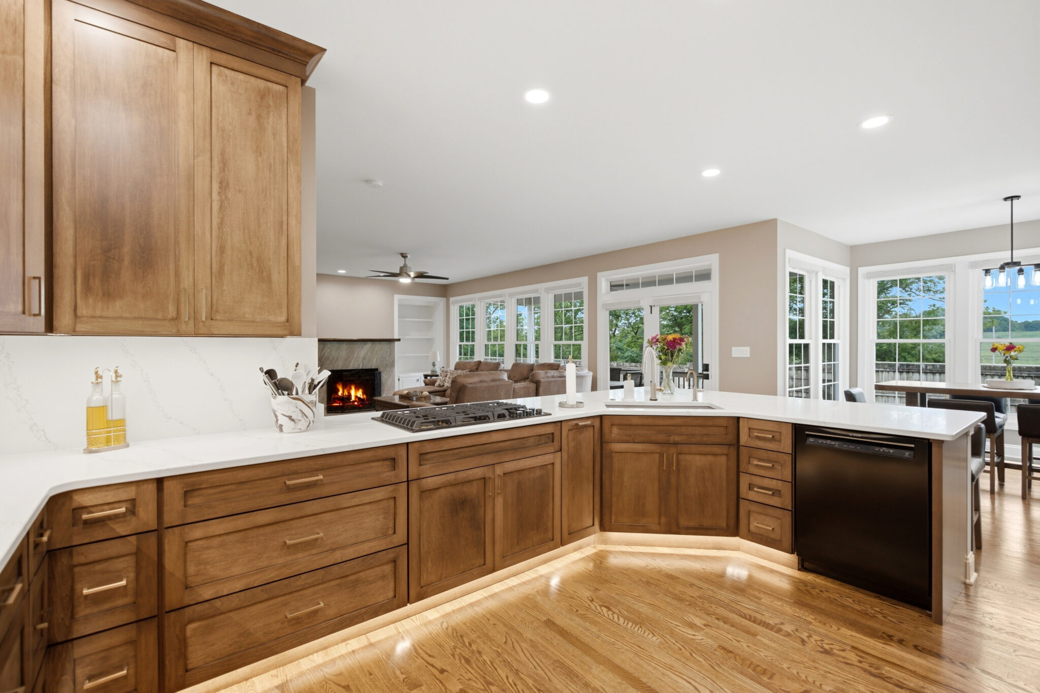 Warm wood kitchen with a large quartz island and a wall of windows, remodeled for the Jackson family in Harpers Ferry