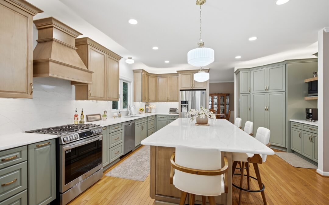 A contemporary kitchen and dining area features natural wood cabinetry, stainless steel appliances, and a round white dining table with modern seating.